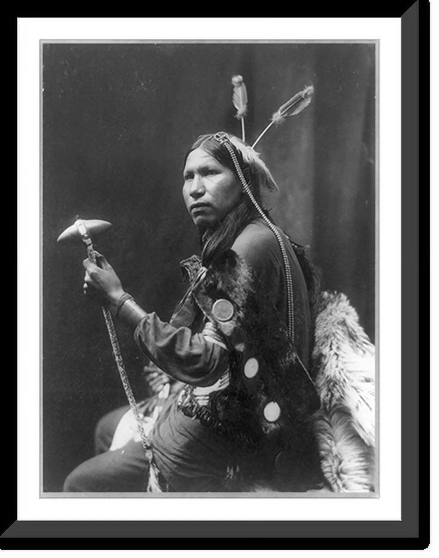 Historic Framed Print, [Afraid of Hawk, three-quarter length portrait, seated, facing left; holding tomahawk], 17-7/8