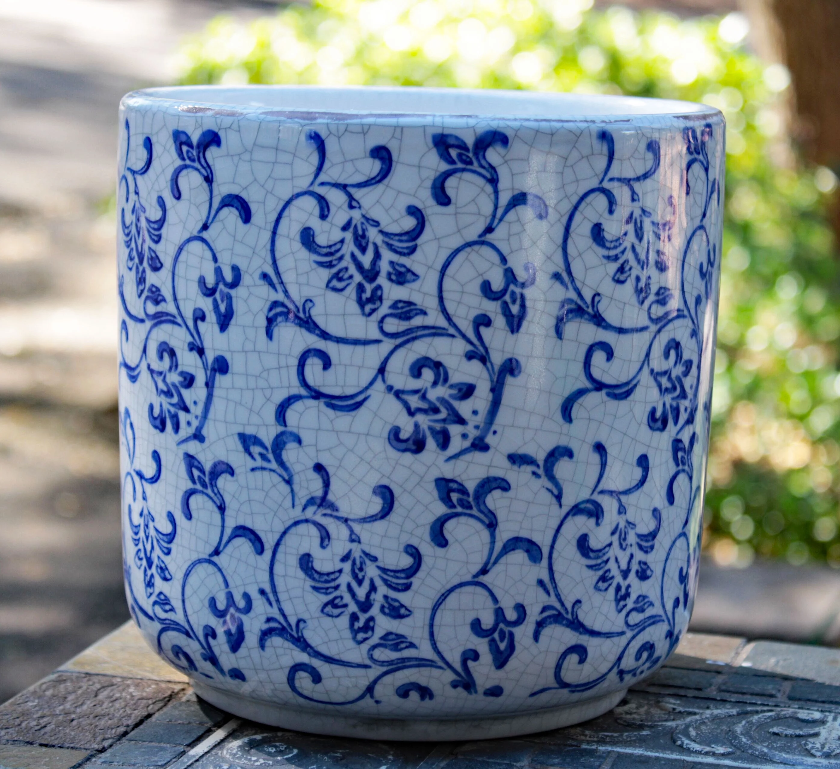 Old world blue and white ceramic cylindrical shaped garden pot or planter Vine pattern