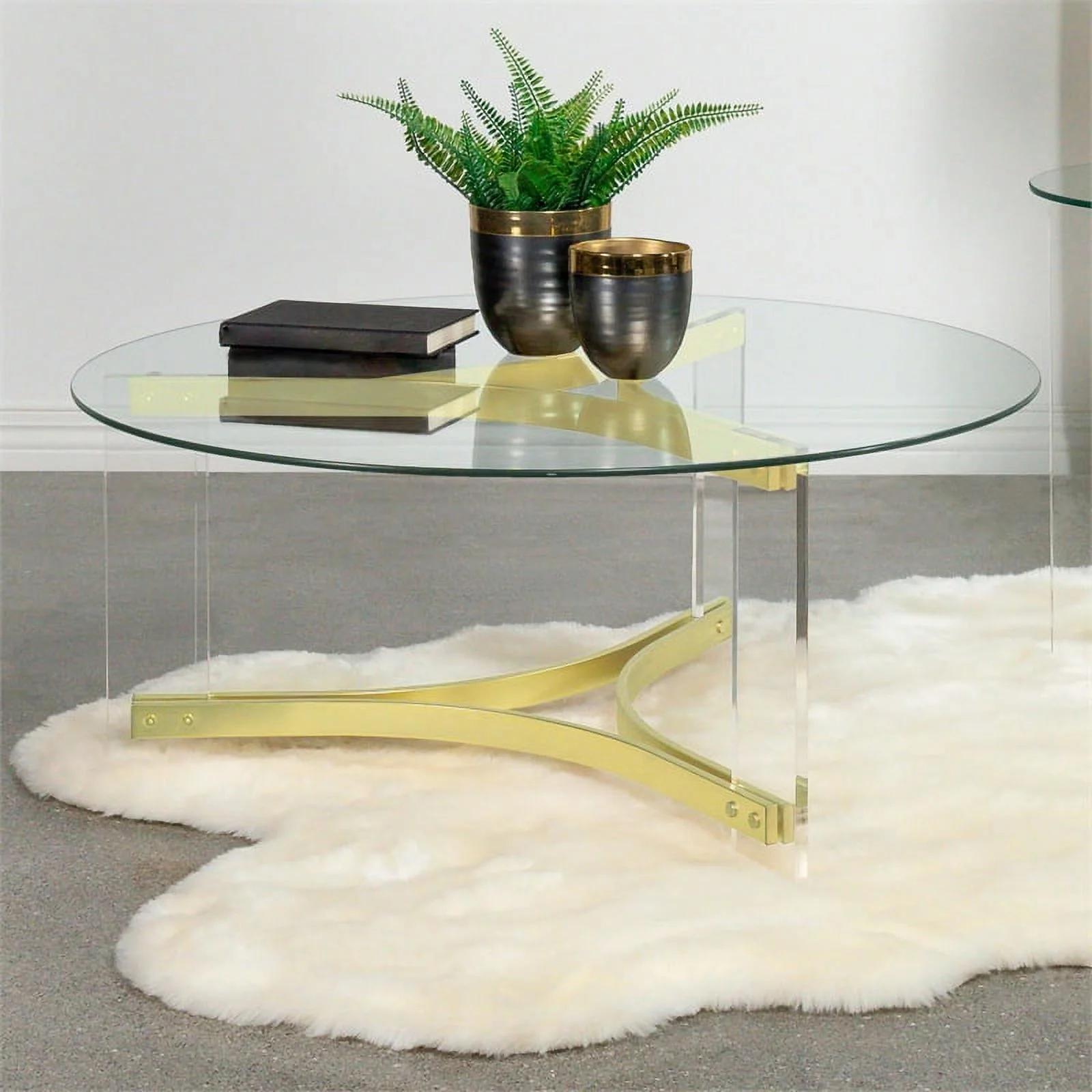 Pemberly Row Round Glass Coffee Table with Acrylic Legs in Clear and Brass